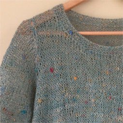 Close up ladies round neck stocking stitch sweater on a timber clothes hanger